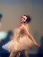 Megan strikes a ballerina pose in a pink tutu